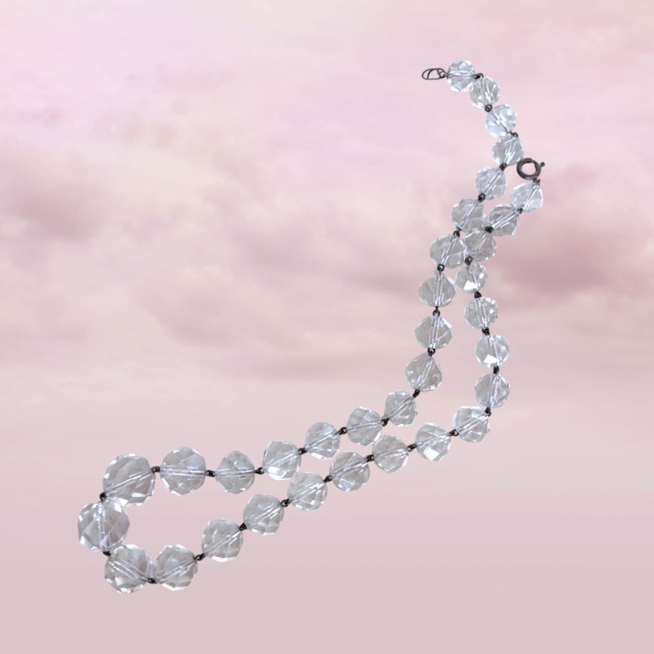 Full view of vintage 1950s Austrian faceted crystal beaded necklace against soft background