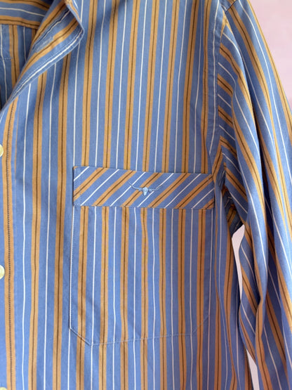 Close-up of a blue and yellow striped shirt with a pocket.