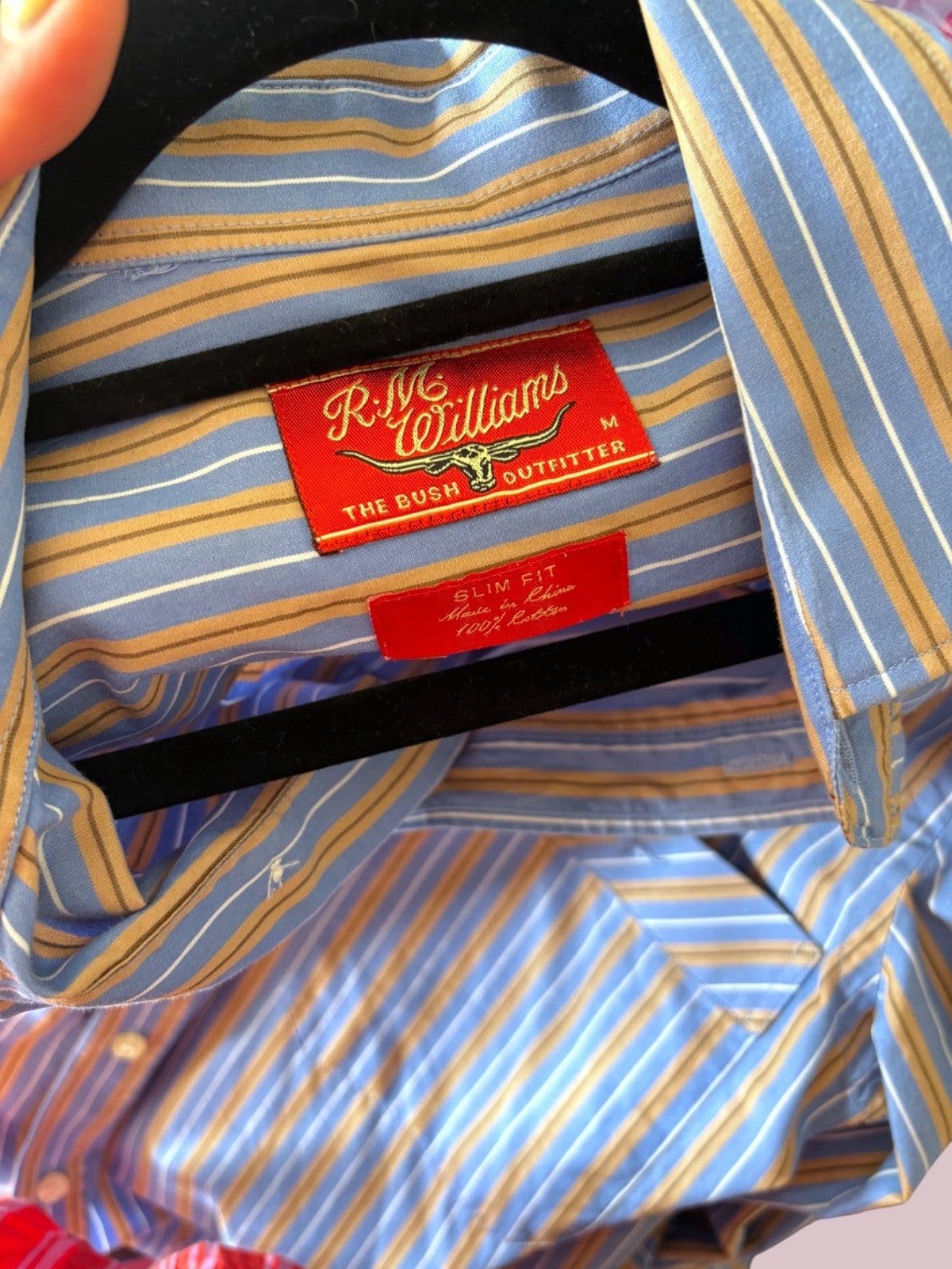 Close-up of a striped shirt with a visible brand label.
