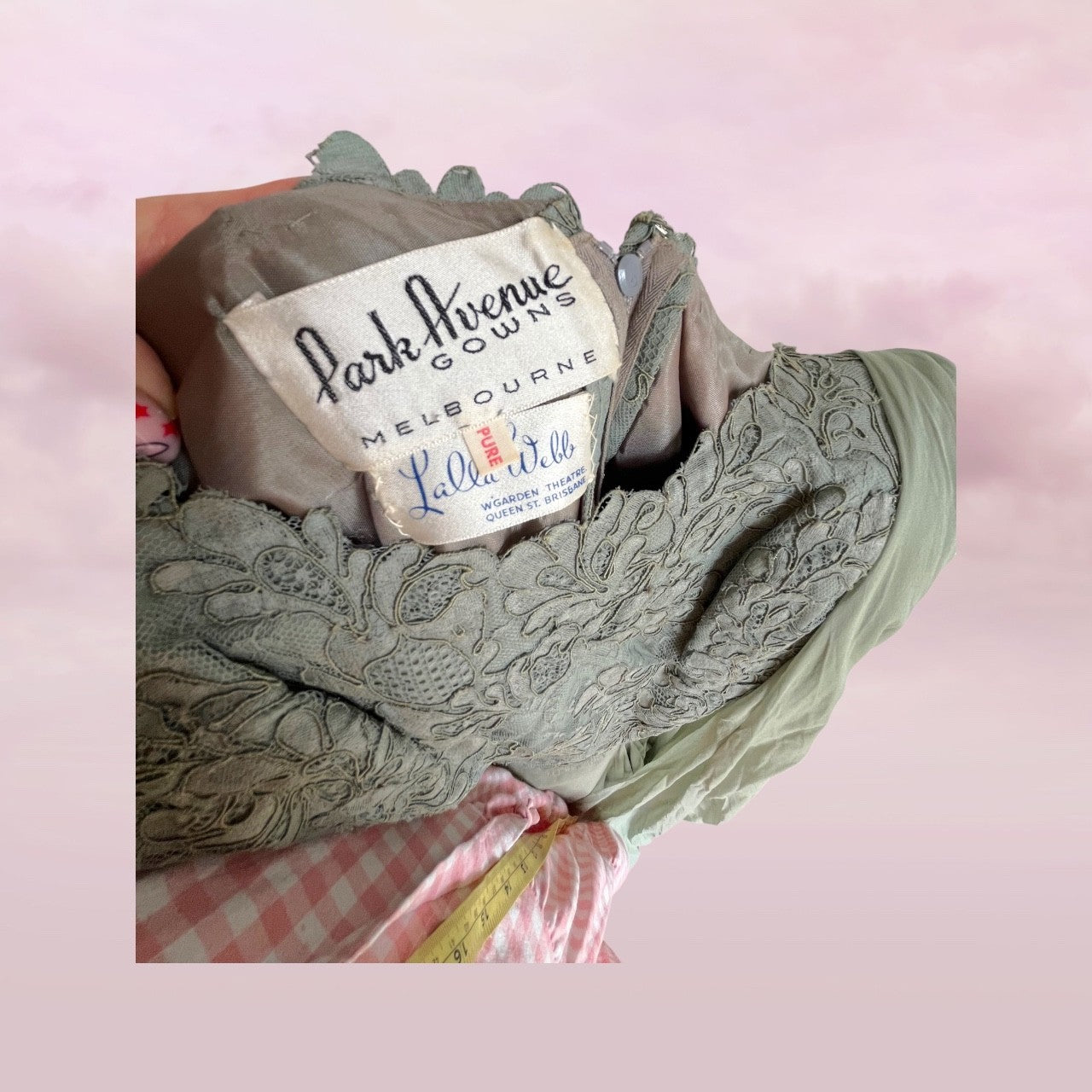 Green lace gauze with 'Park Avenue Gowns Melbourne' label on a pink checkered background