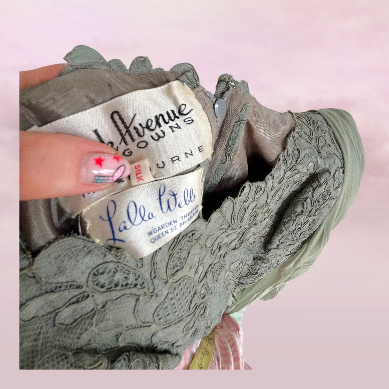 Embroidered green shoe with visible brand labels on a pink background