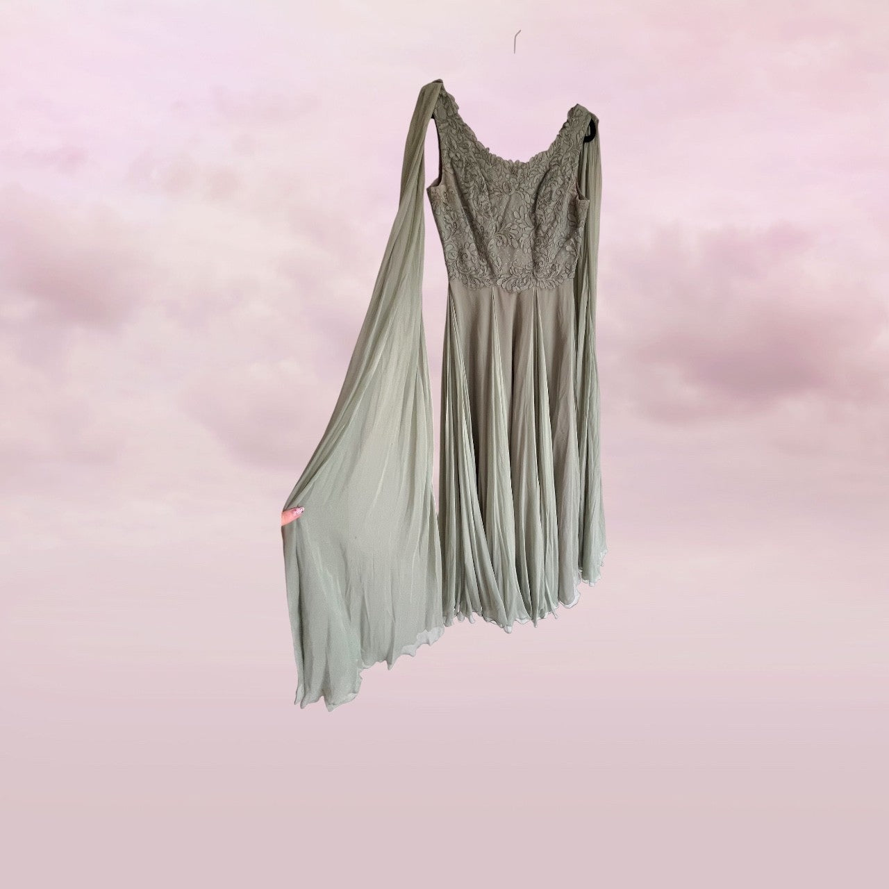 Green dress with lace top on a pink background