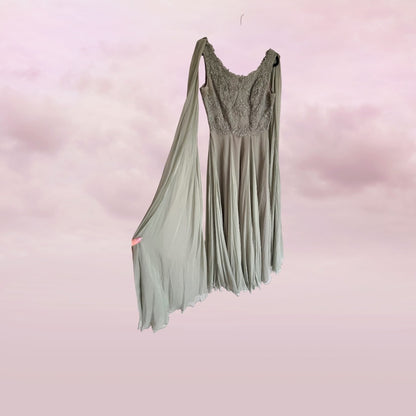 Green dress with lace top on a pink background