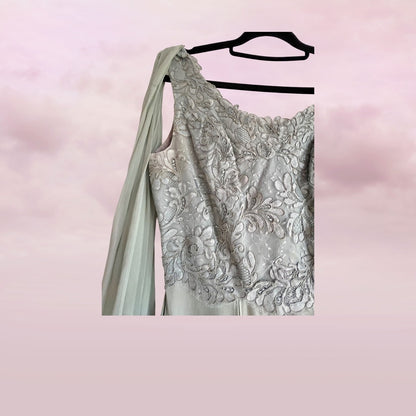 Silver evening gown with floral lace details on a pink background