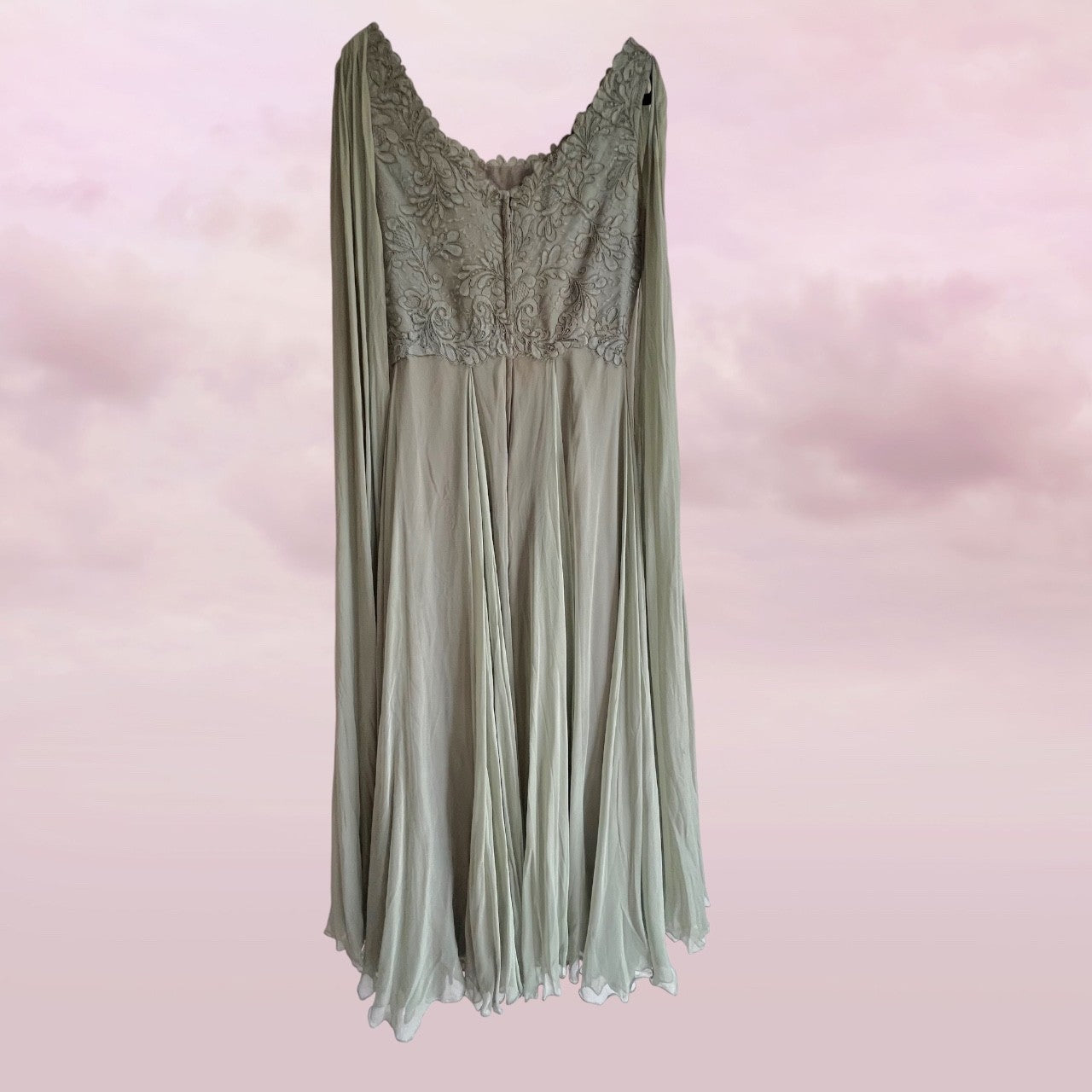 Sage green dress with lace detailing on a pink background