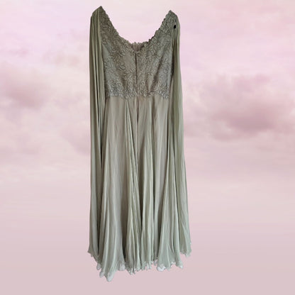 Sage green dress with lace detailing on a pink background