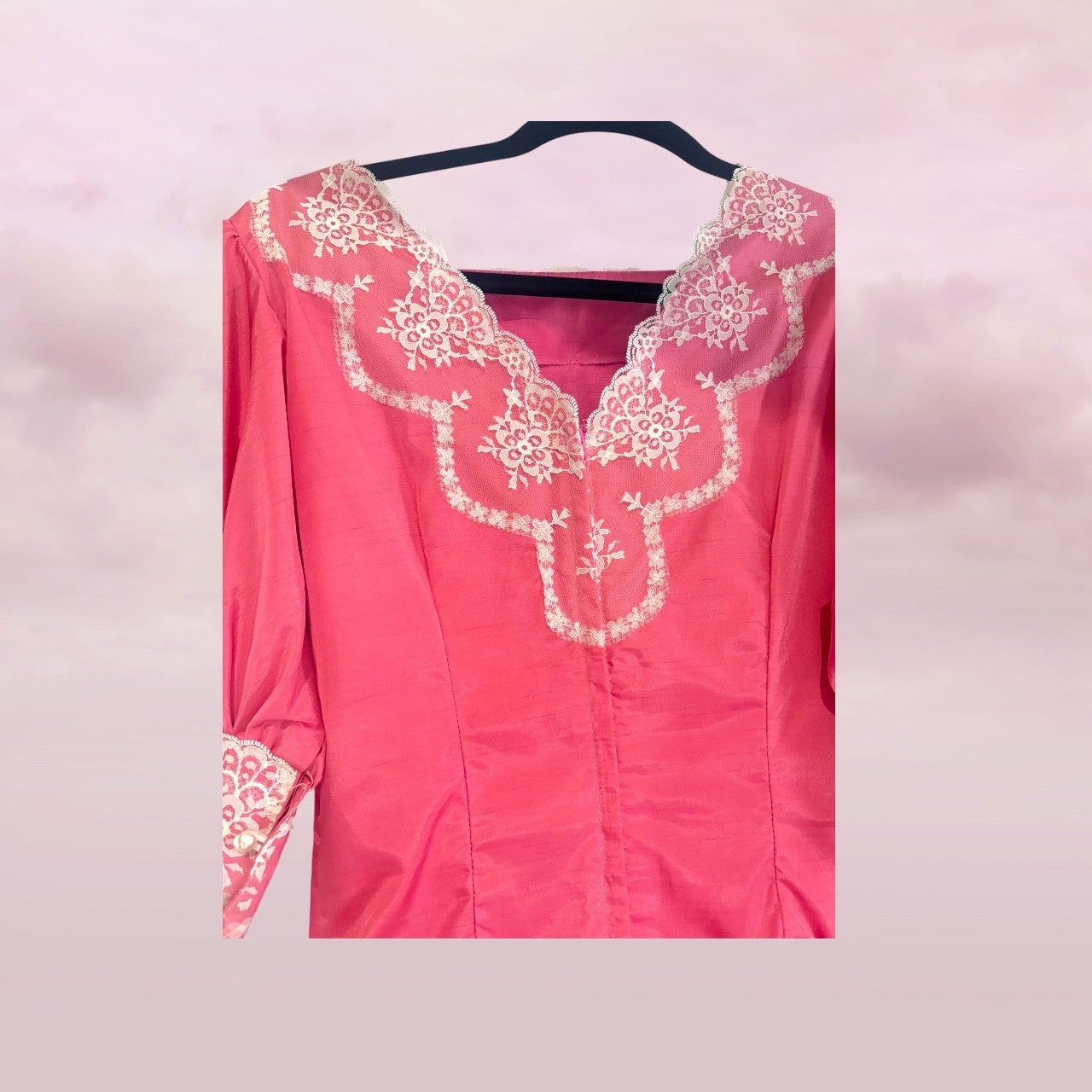 Pink top with white lace details on a pink background
