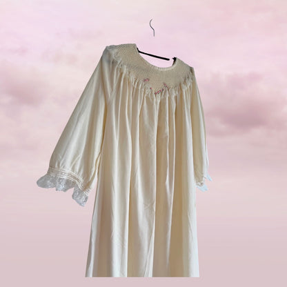 Beige nightgown with lace details on a pink background