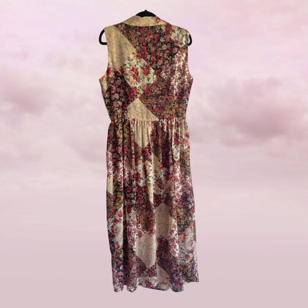 Floral dress on a hanger against a pink background