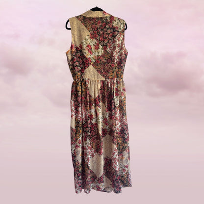 Floral dress on a hanger against a pink background