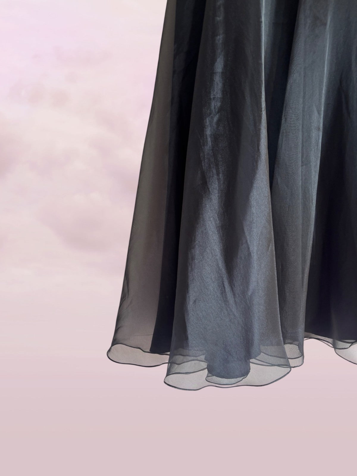 Black sheer fabric on a soft pink background