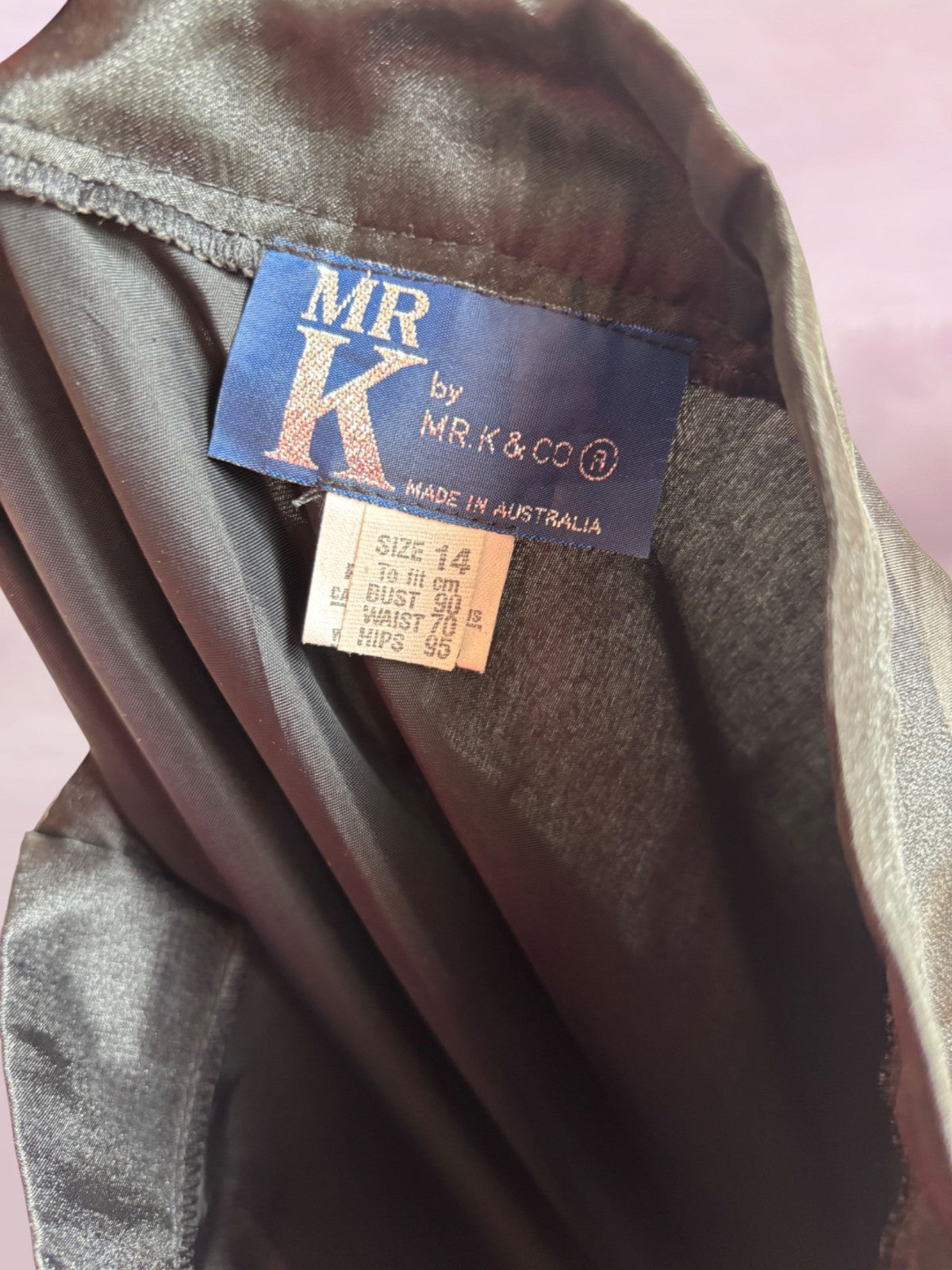 Clothing label with 'MR K' branding on a garment.