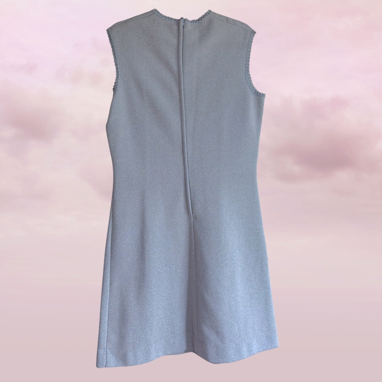 Light blue sleeveless dress on a pink background