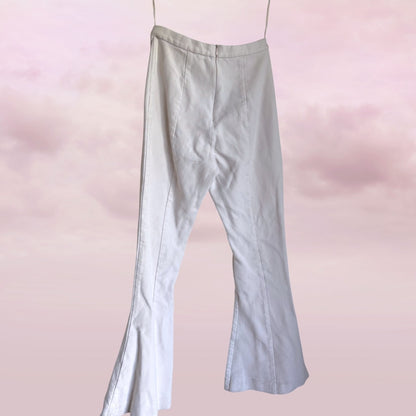 white pants on a pink gradient background