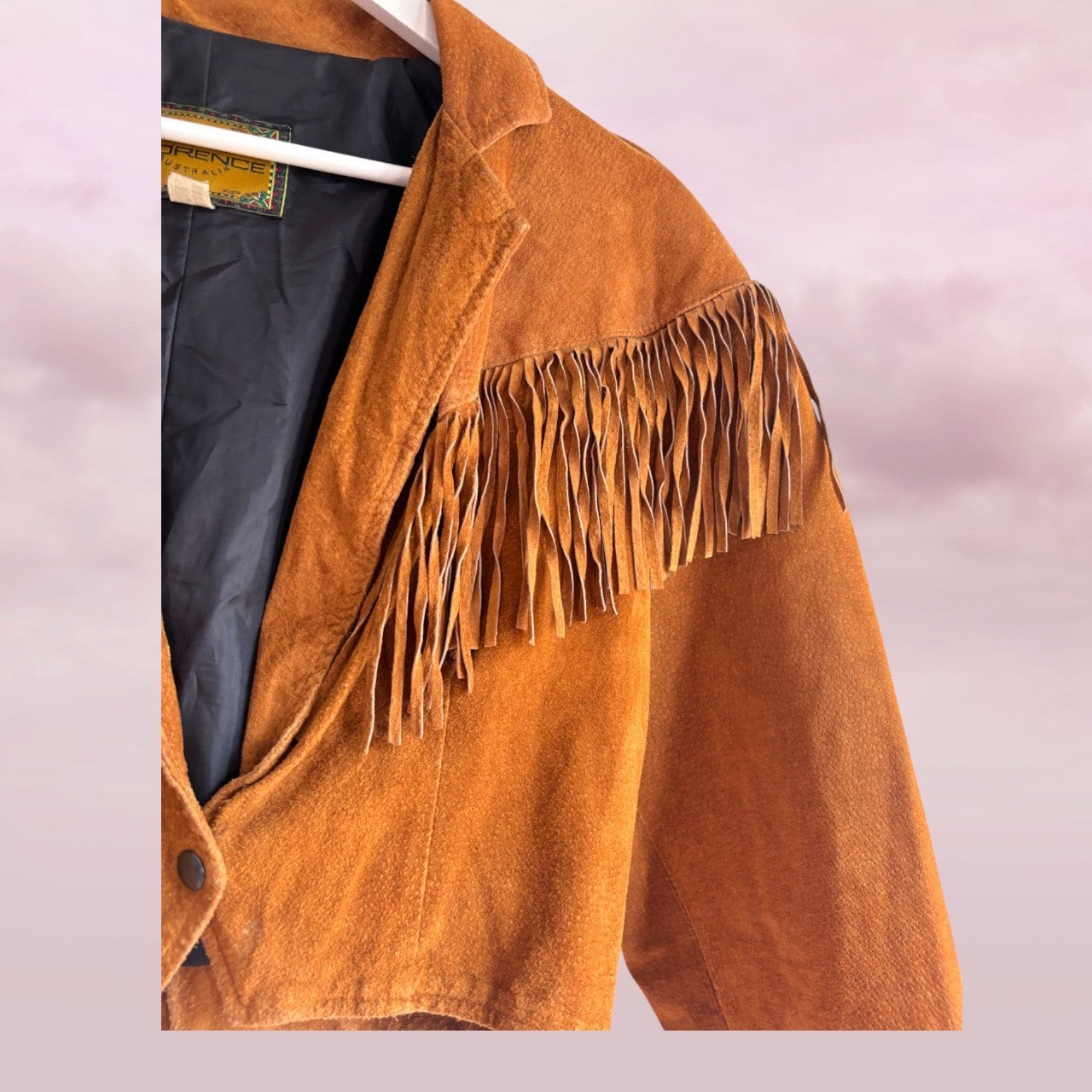 Brown suede jacket with fringes on a white background