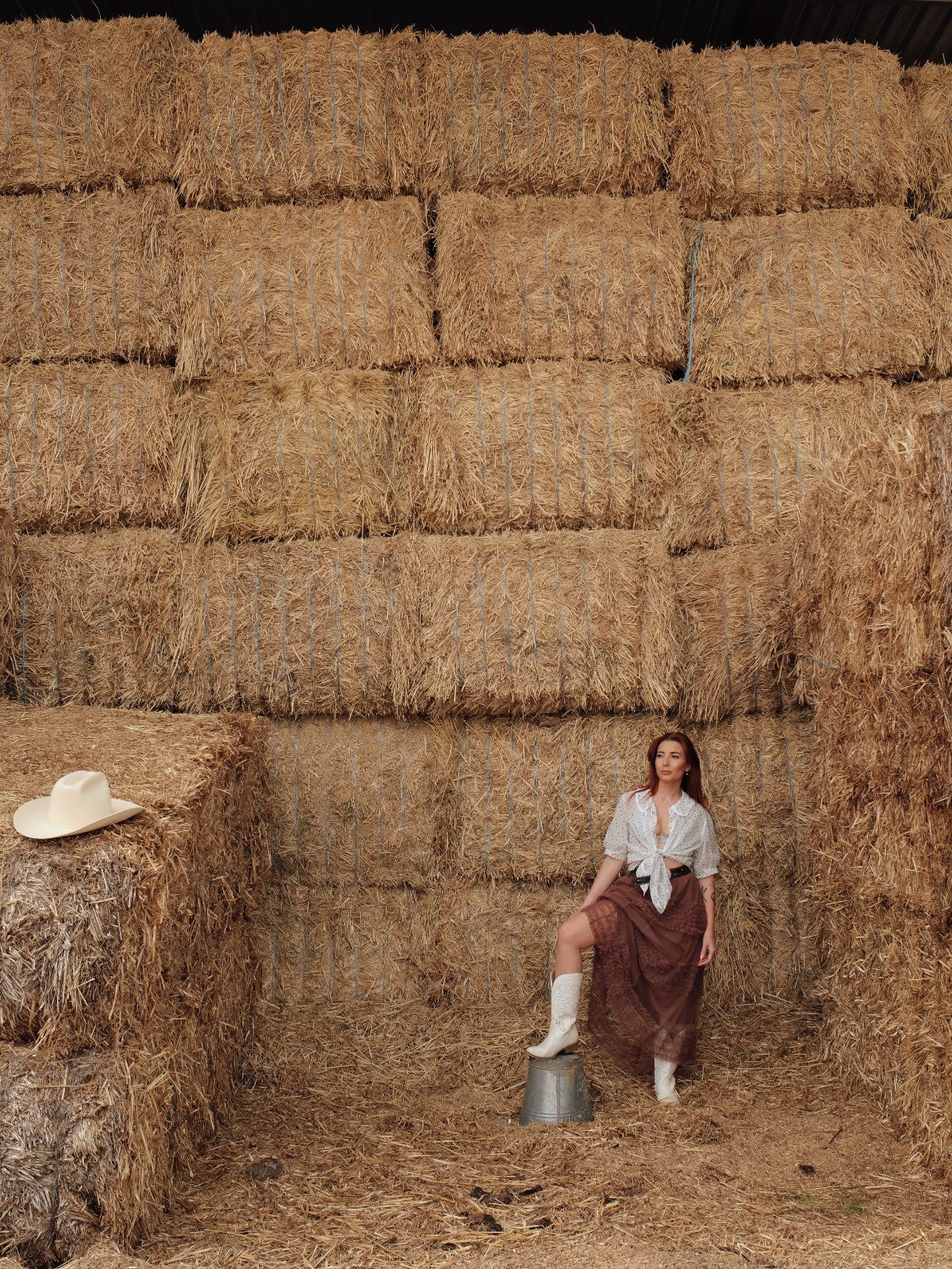 Woman standing infront of haybales