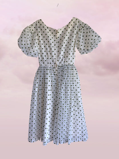 Polka dot dress on a pink background