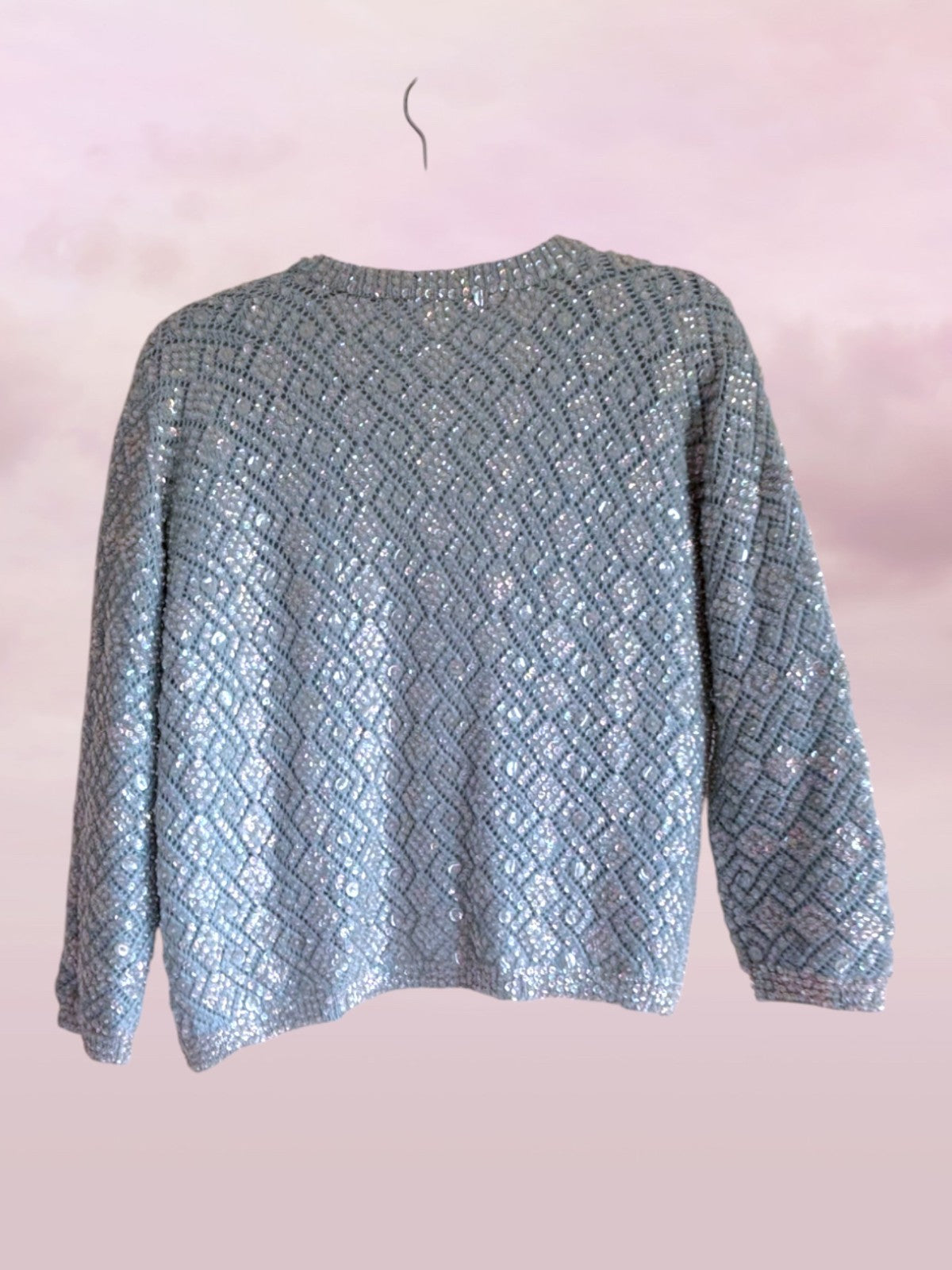 Textured blue sweater on a pink background