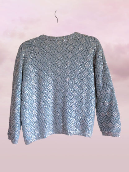 Textured blue sweater on a pink background