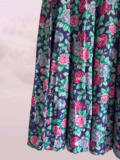 Floral patterned fabric with pink and green flowers on a dark background