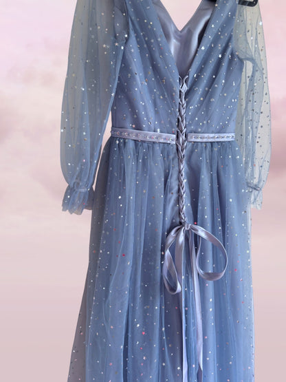 Blue dress with star patterns on a pink background