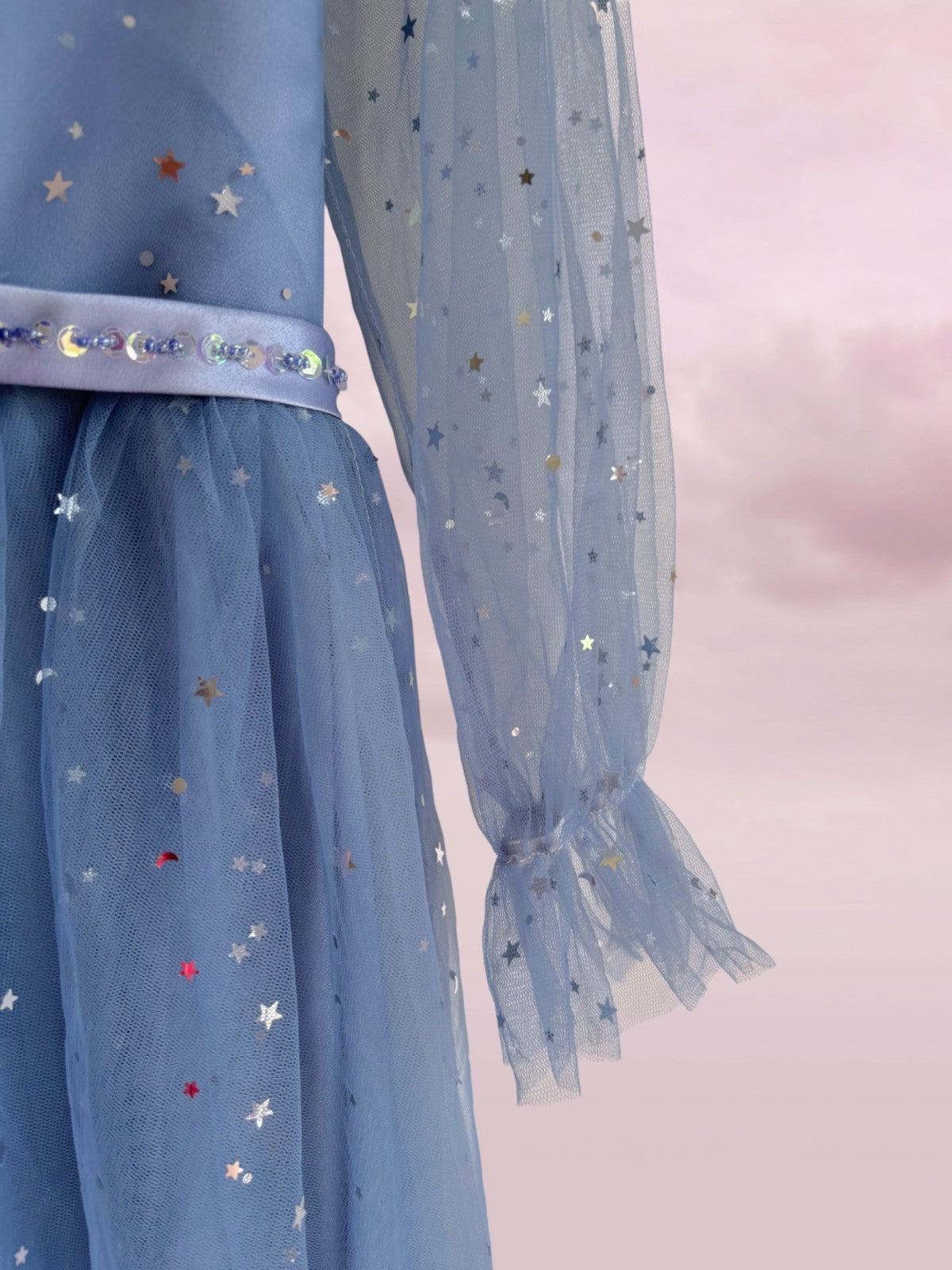 Blue dress with star patterns on a light pink background