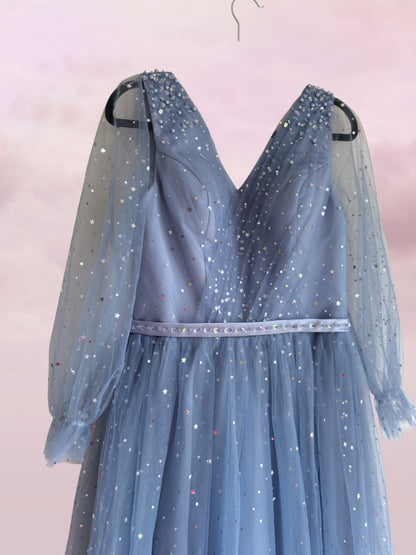 Blue dress with sheer sleeves on a pink background