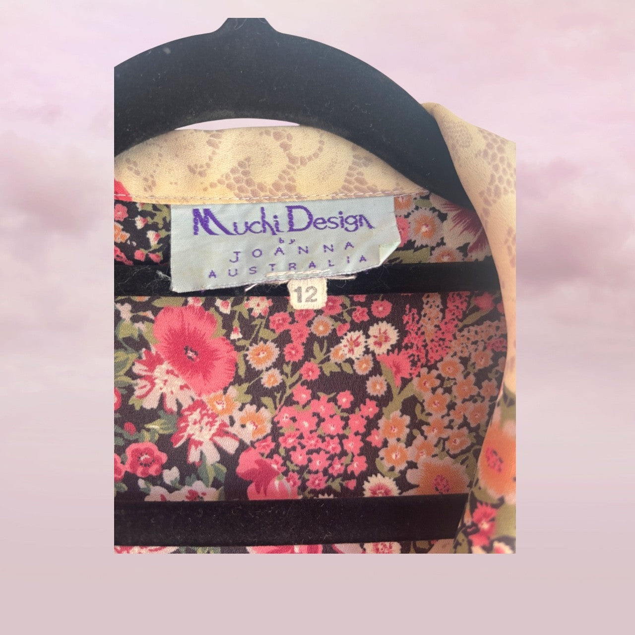 Floral patterned product with 'Muchi Design by Joanna Australia' label on a pink background