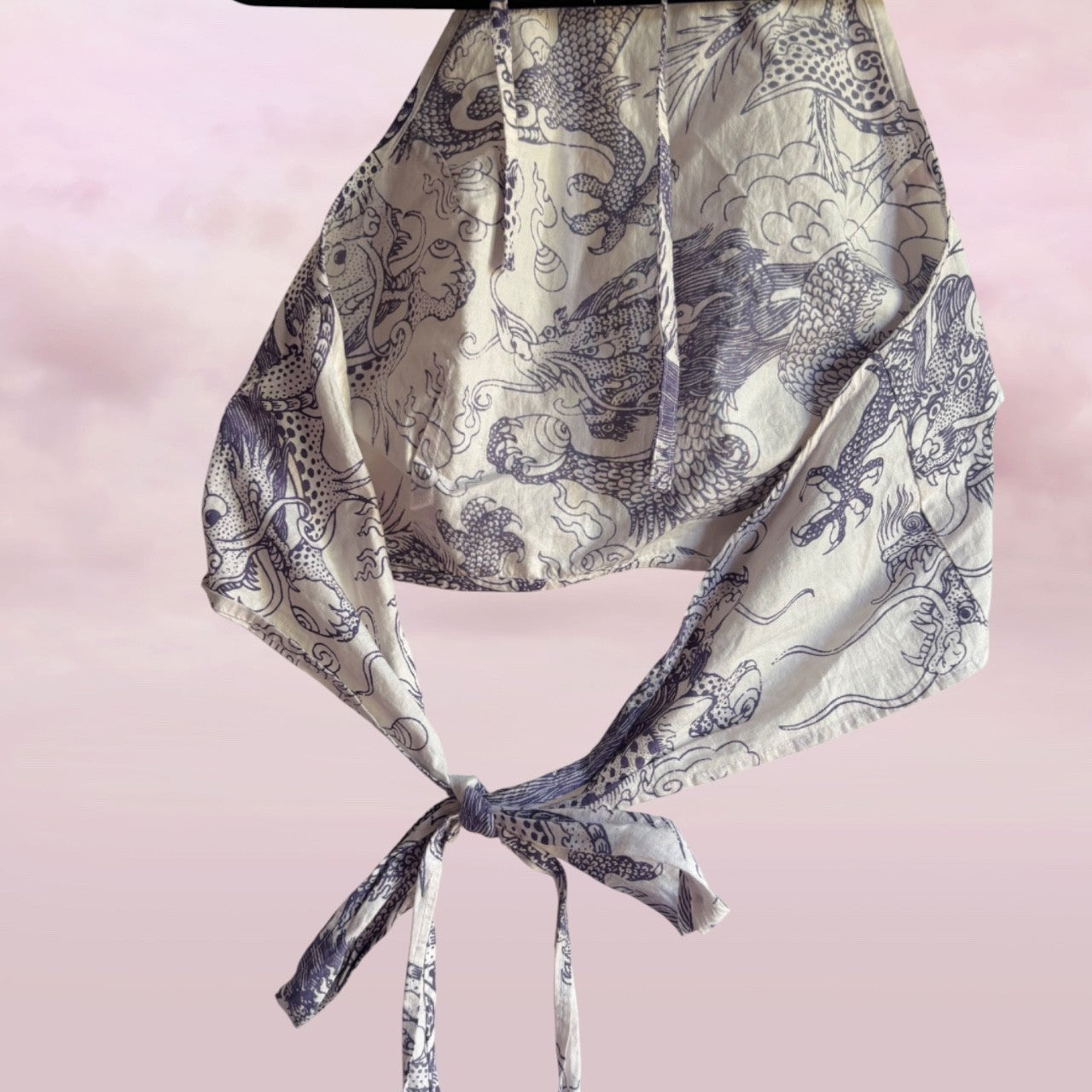 Patterned scarf with a knot on a pink background