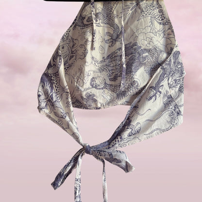 Patterned scarf with a knot on a pink background