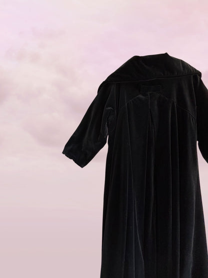 Black dress on a light pink background
