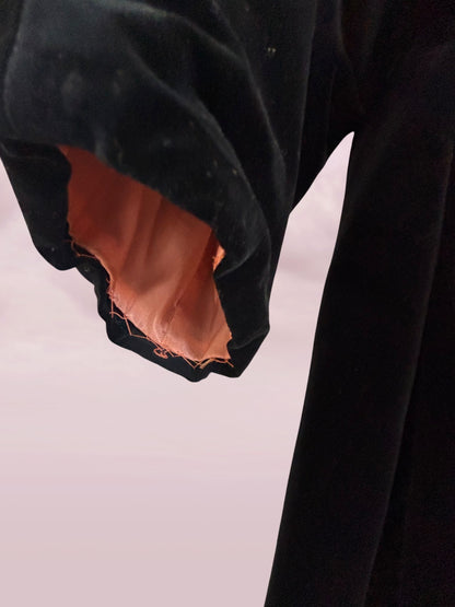 Close-up of a black garment with brown lining on a white background